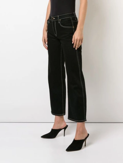 Shop Khaite Flared Cropped Jeans - Black