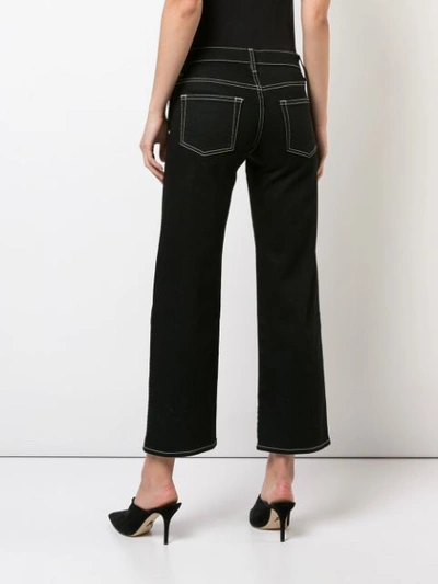 Shop Khaite Flared Cropped Jeans - Black