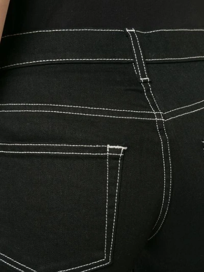 Shop Khaite Flared Cropped Jeans - Black