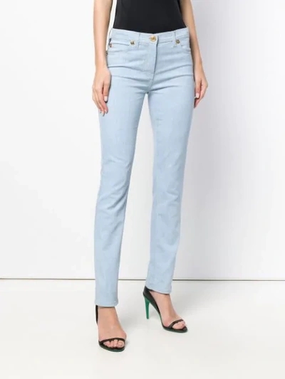 Shop Versace Medusa Stud Skinny Jeans In Blue