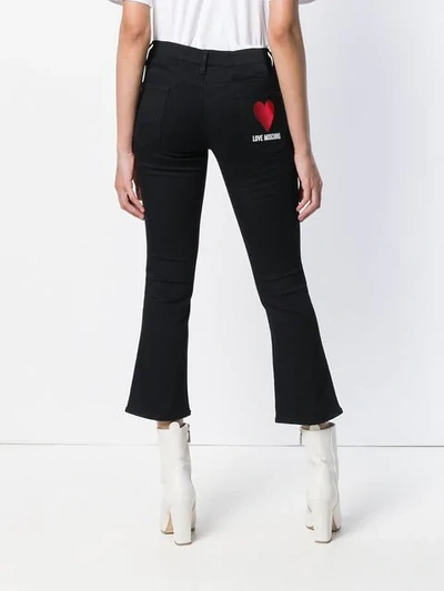 Shop Love Moschino Logo Print Cropped Jeans In Black