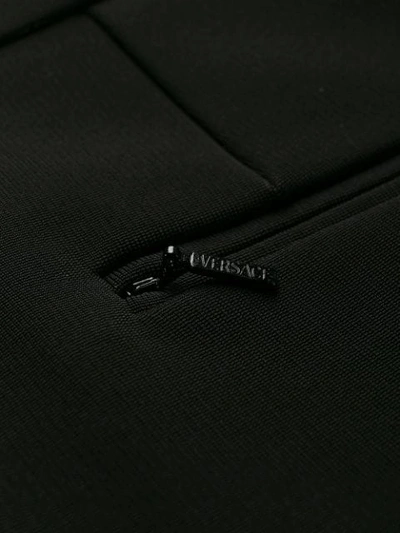 Shop Versace High-waist Skinny Trousers In Black