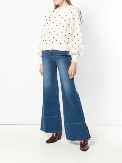 Shop Frame Mid Rise Flared Jeans In Blue