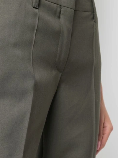 Shop Prada Cropped Pleated Trousers In Olive
