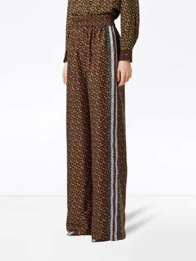 Shop Burberry Monogram Print Trousers In Brown