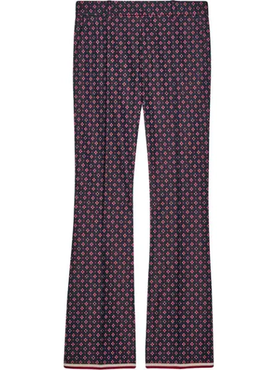 Shop Gucci Geometric G Print Bootcut Trousers In Red