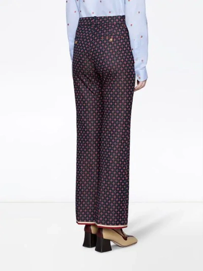 Shop Gucci Geometric G Print Bootcut Trousers In Red