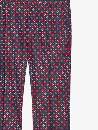 Shop Gucci Geometric G Print Bootcut Trousers In Red