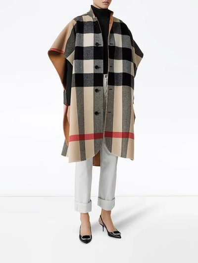 Shop Burberry Reversible Check Poncho In Brown