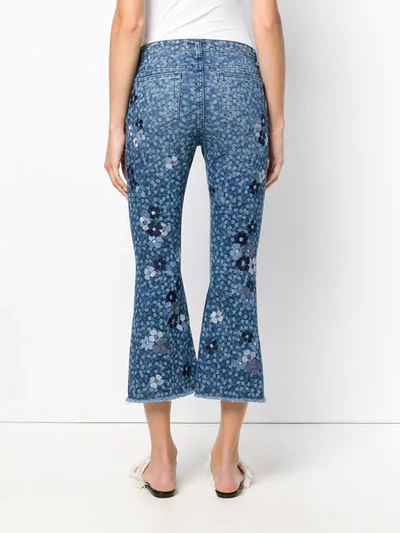 Shop Michael Michael Kors Floral Printed Flared Jeans In Blue