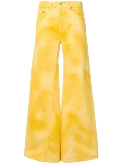 Shop Ganni Flared Denim Jeans In Yellow