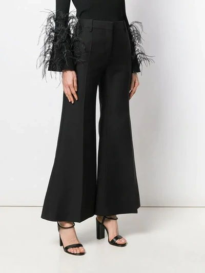 Shop Valentino Flared Trousers In Black