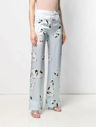 Shop Genny Floral Print Trousers In Blue