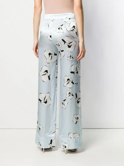 Shop Genny Floral Print Trousers In Blue