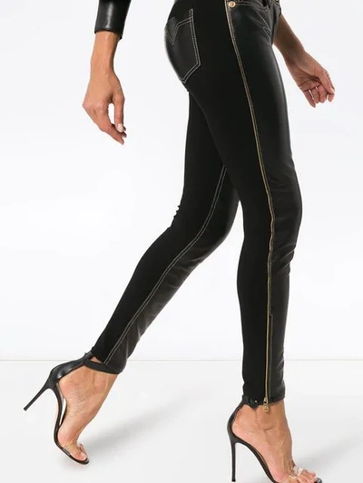 Shop Versace Slim Fit Trousers In Black