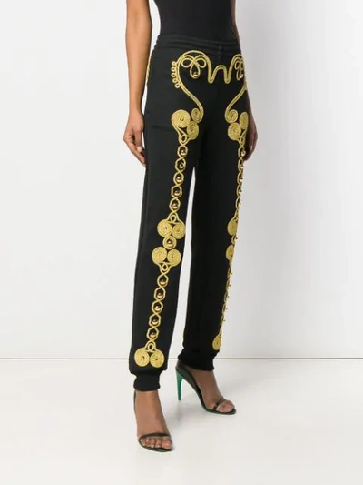 Shop Moschino Embroidered Track Pants In Black