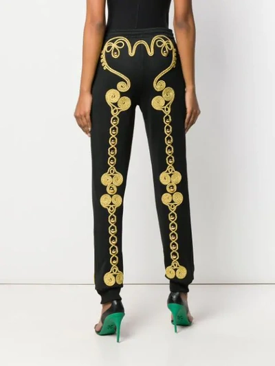 Shop Moschino Embroidered Track Pants In Black