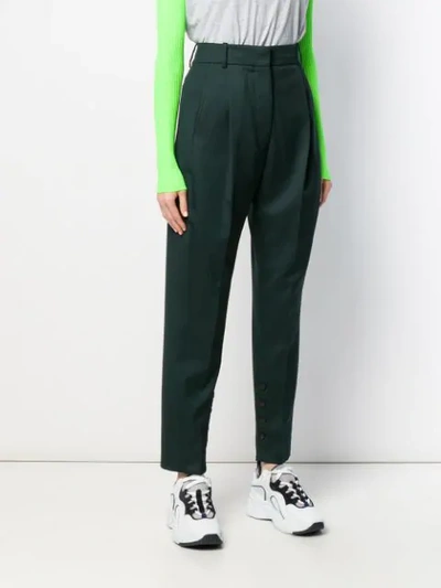 Shop Acne Studios Pleated Tapered Trousers In Green