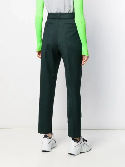 Shop Acne Studios Pleated Tapered Trousers In Green