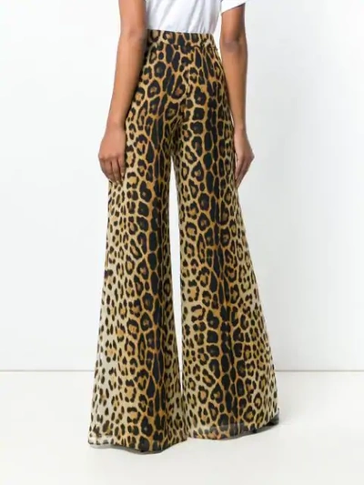 Shop Moschino Flared Leopard Print Trousers In Neutrals