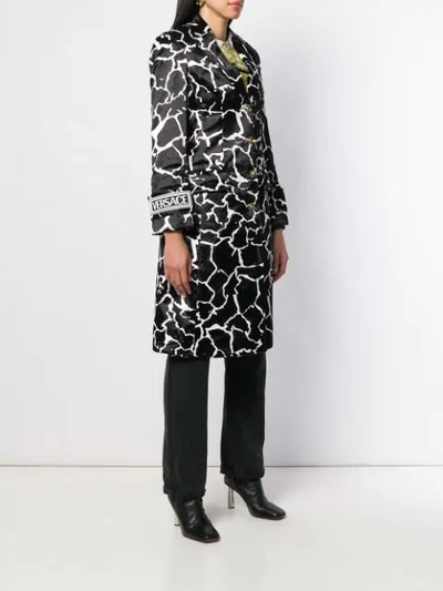 Shop Versace Marble Effect Printed Coat In Black