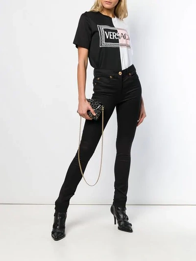 Shop Versace Skinny Trousers In Black