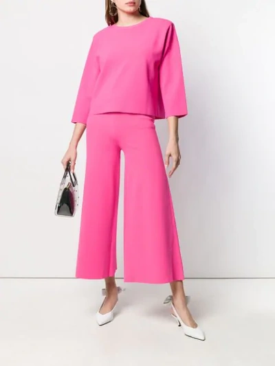 Shop Moschino Cropped Flare Trousers In Pink