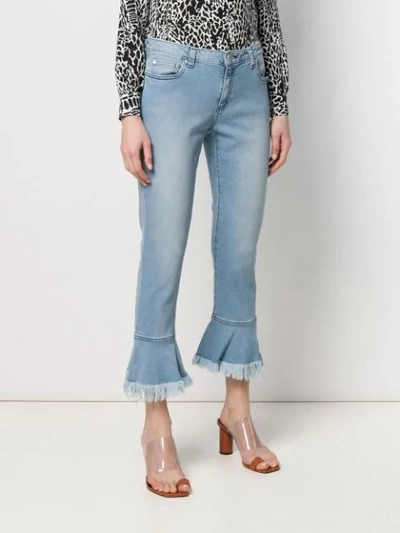 Shop Michael Michael Kors Fringed Hem Jeans In Blue