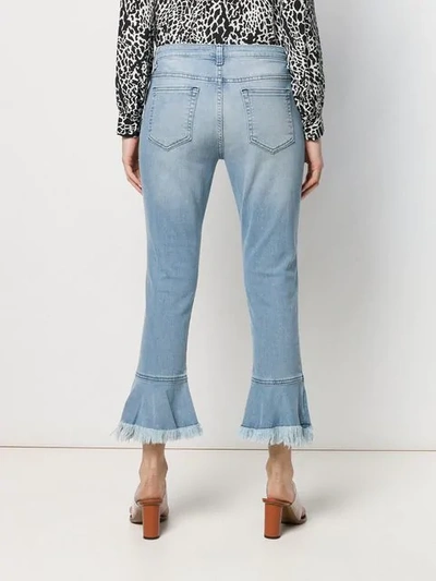 Shop Michael Michael Kors Fringed Hem Jeans In Blue