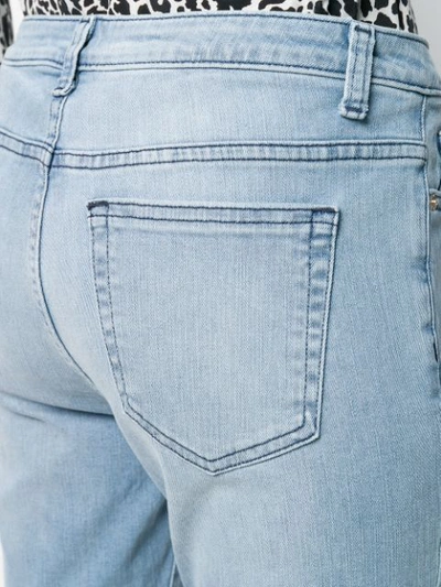Shop Michael Michael Kors Fringed Hem Jeans In Blue
