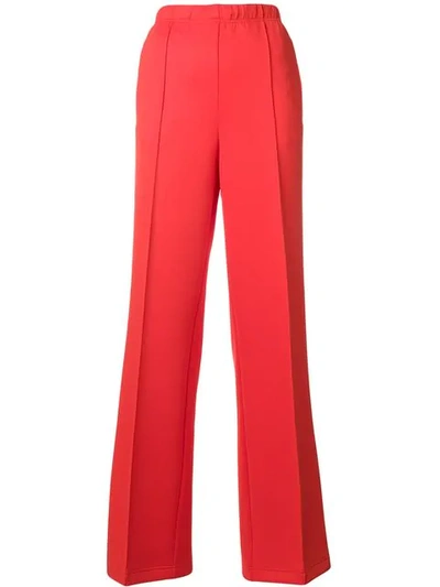 Shop Prada Logo Patch Flared Trousers In Yellow