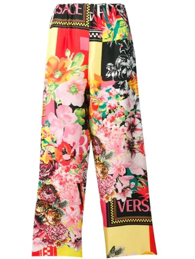Shop Versace Floral Print Logo Trousers In Yellow