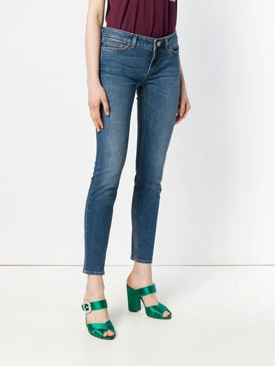 Shop Dolce & Gabbana Skinny Jeans With Floral Button In Blue