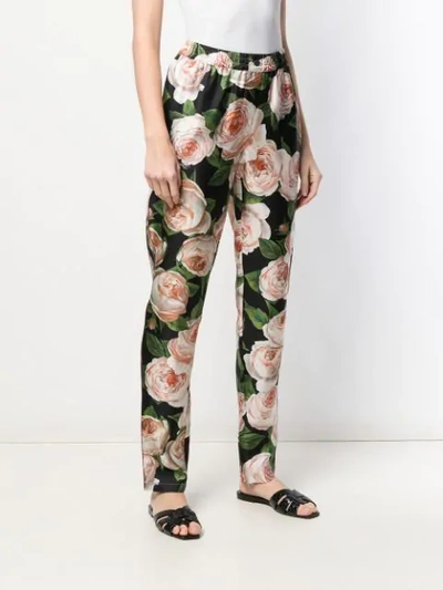 Shop Dolce & Gabbana Rose Print Trousers In Black