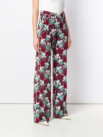 Shop Valentino Floral Print Trousers In Red