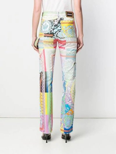 Shop Versace Technicolor Baroque Print Jeans In White