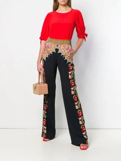 Shop Etro Printed Flared Trousers In Black