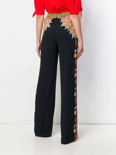 Shop Etro Printed Flared Trousers In Black