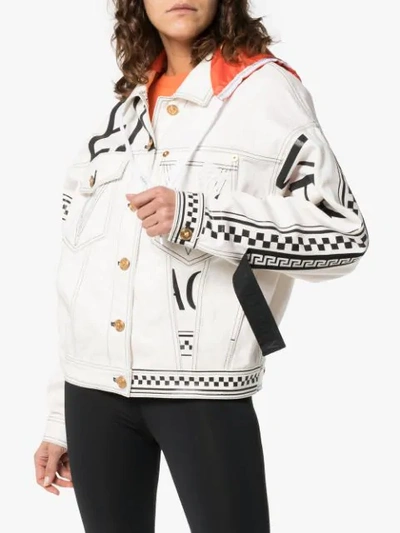 Shop Versace Logo Print Hooded Denim Jacket In White