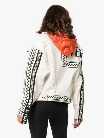 Shop Versace Logo Print Hooded Denim Jacket In White