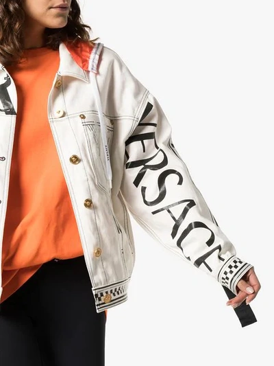 Shop Versace Logo Print Hooded Denim Jacket In White