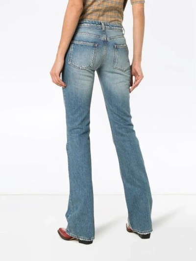 Shop Saint Laurent Button Up Flared Jeans In Blue