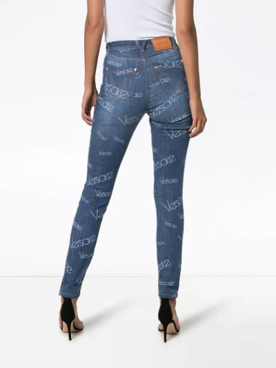 Shop Versace All-over Logo Print Skinny Jeans In Blue