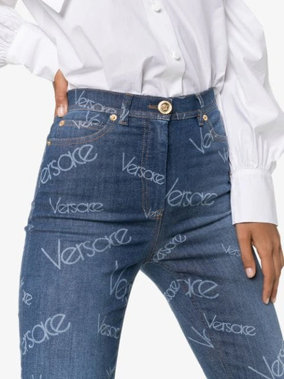 Shop Versace All-over Logo Print Skinny Jeans In Blue