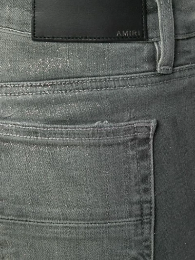 Shop Amiri Distressed Paint Effect Jeans In Grey
