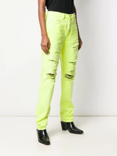 Shop Amiri Distressed Slouch Jeans In Yellow