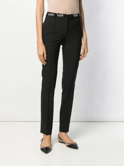 Shop Valentino Belted Vltn Skinny Trousers In Black