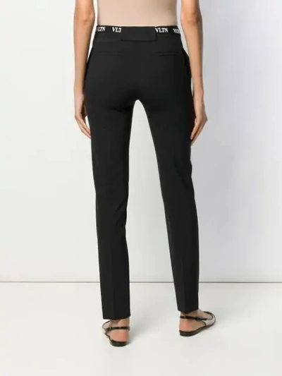 Shop Valentino Belted Vltn Skinny Trousers In Black