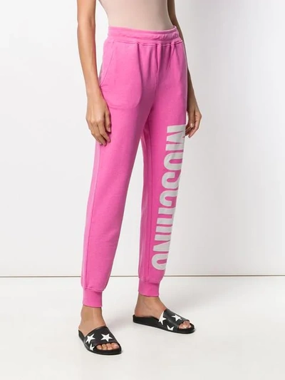 Shop Moschino Logo Print Track Trousers In Pink