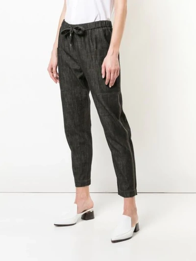 Shop Brunello Cucinelli Tapered Denim Style Trousers In Black